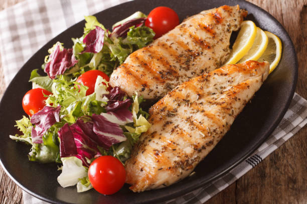 istock Grilled chicken breast with mixed salad close-up. horizontal 958004034