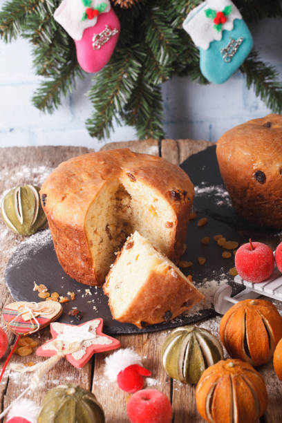 istock Christmas cake panettone surrounded by holiday decoration close-up. vertical 958004736