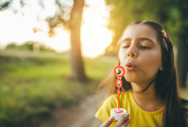 child with short hair in red clothes in the park