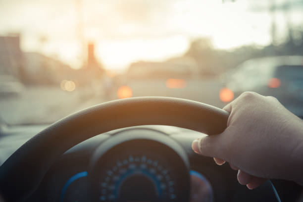 istock people driving car on day time. 958013104