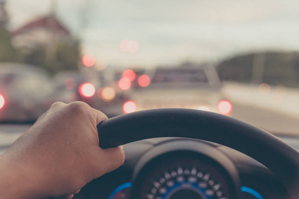 istock people driving car on day time. 958013138