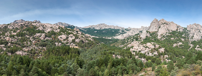 Panoramic views of La Pedriza from the Giner de los Rios refuge, in Guadarrama Mountains National Park, province of Madrid, Spain. It can be seen Las Torres (The Towers), Las Buitreras (Vulture) and El Pajaro (The Bird) peaks