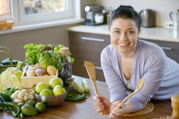 istock woman cooking in the kitchen 958015716
