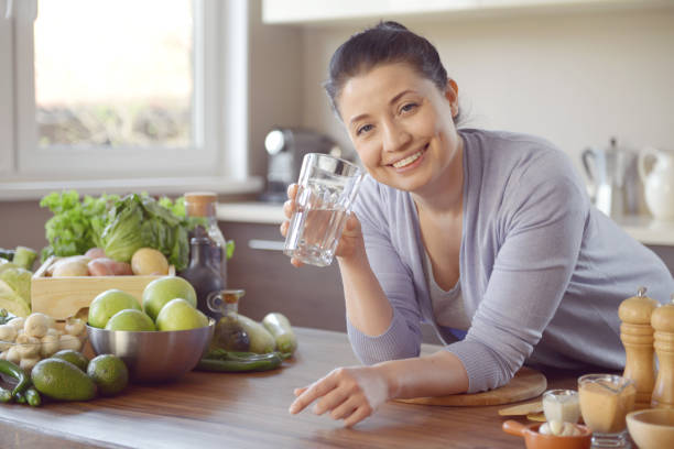 istock woman cooking in the kitchen ( drinking) 958020558