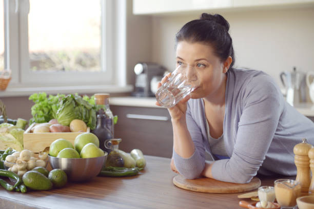 istock woman cooking in the kitchen ( drinking) 958020894