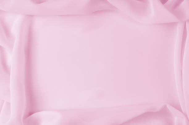 istock Texture, background, pattern. Silk fabric pale pink, abstract folds 958029144