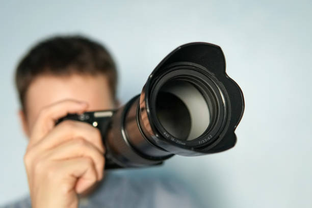 istock Young photographer on blue background 958031026