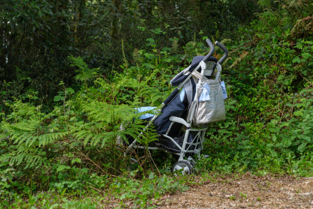 An old shopping cart/trolley sits on a gravel road outside the Furber's Scrapyard in Shropshire, England.