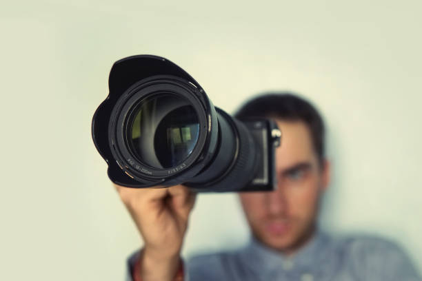 istock Photographer holding mirrorless camera for check his photo in selective focus. 958031160