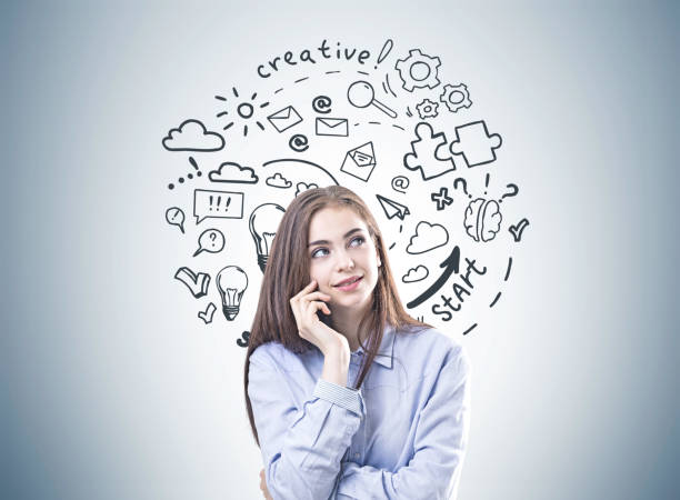 istock Dreamy young woman in a blue shirt, creative thinking 958031386