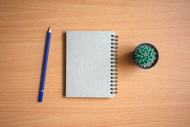 istock Notepad with pencil on wood board background.using wallpaper for education, business photo.Take note of 