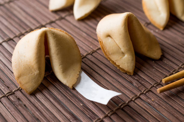 istock Chinese Fortune Cookies on Bamboo Mat with Chopsticks and Paper. 958034256