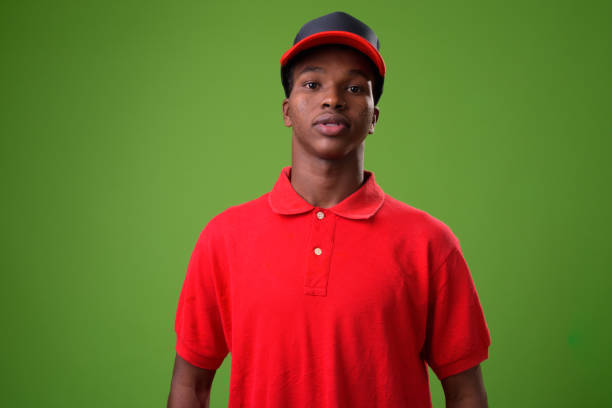 istock Young African man against green background 958034288