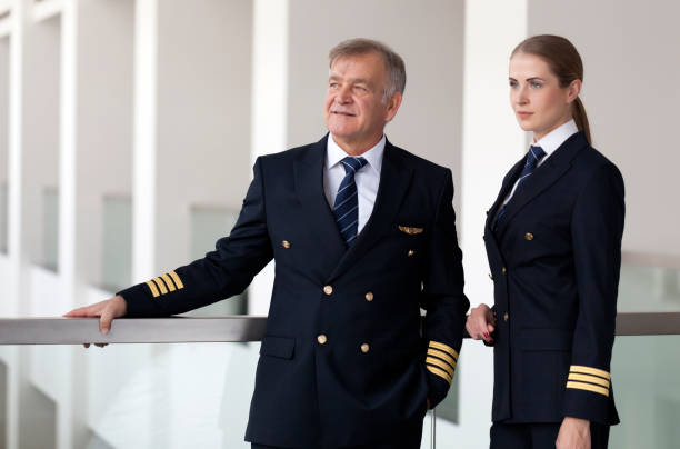 istock Experienced Senior airliner captain talking with his co-pilot before flight 958034582
