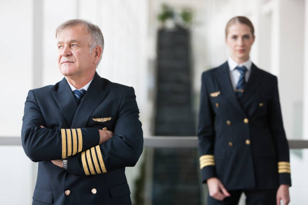 istock Arms folded Senior captain and his female co-pilot 958034820