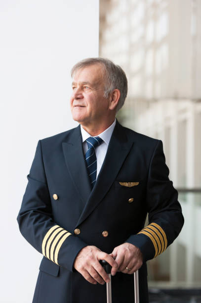 istock Experienced Senior pilot waiting at the airport lobby for flight 958038082