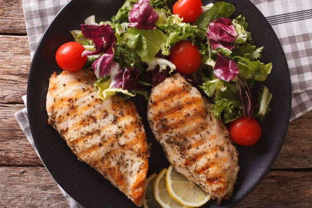 istock Grilled chicken breast with mixed salad close-up. horizontal top view 958044360