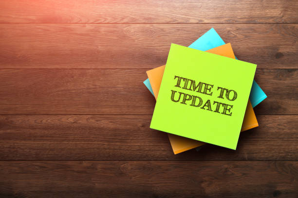 istock Time To Update, the phrase is written on multi-colored stickers, on a brown wooden background. Business concept, strategy, plan, planning. 958046146