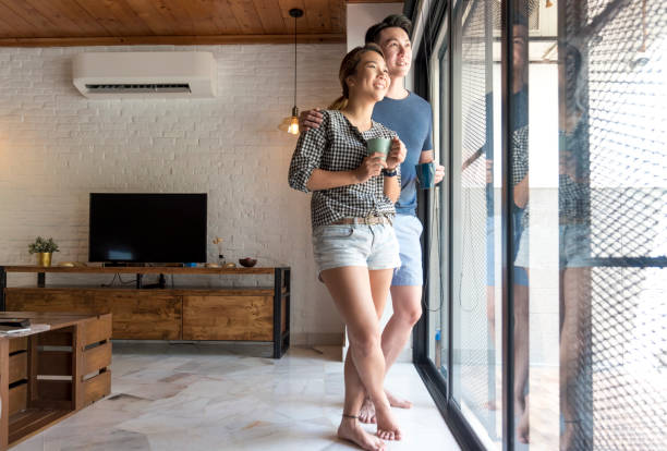 istock Couple standing by the window 958049346