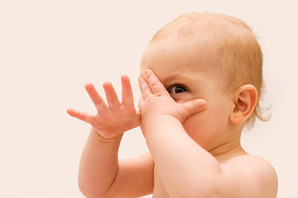 baby hiding with hands XL stock photo