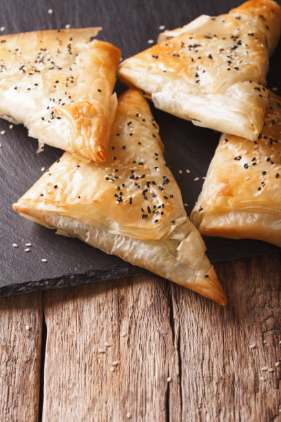 istock Freshly baked filo pastry with chicken, spinach and cheese close-up. Vertical 958054080