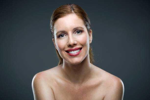 istock Beautiful young woman looking at camera over black background. 958059752