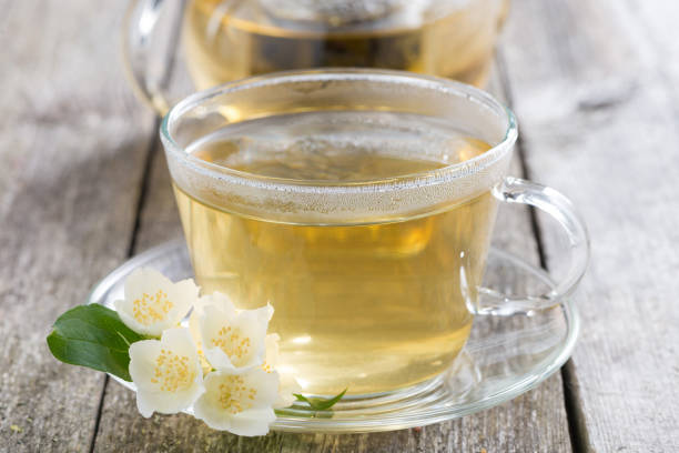 istock cup of green tea with jasmine on wooden table 958059760