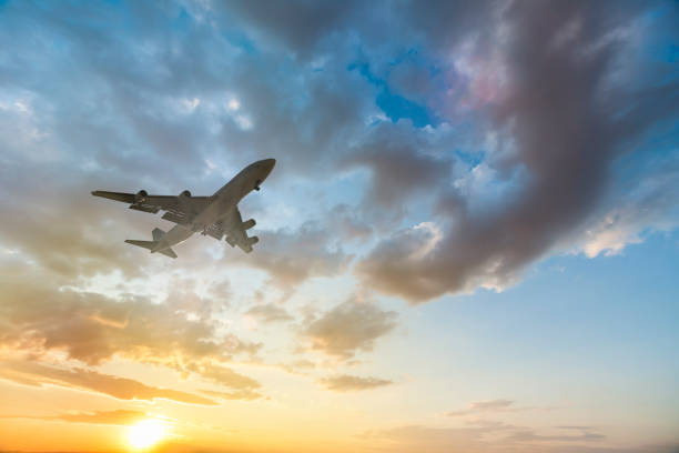 istock Airplane taking off at beautiful sunset 958061632