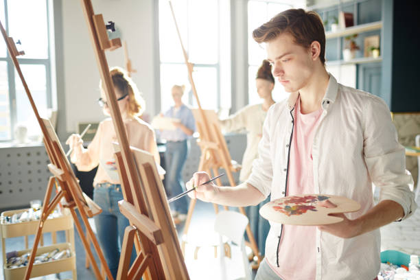 istock Concentrating on painting 958065120