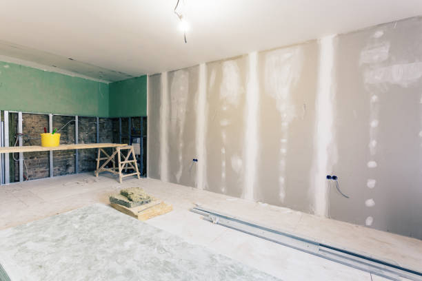 istock Working process of installing metal frames and plasterboard drywall for gypsum walls and materials in apartment is under construction, remodeling, renovation, extension, restoration and reconstruction 958065476