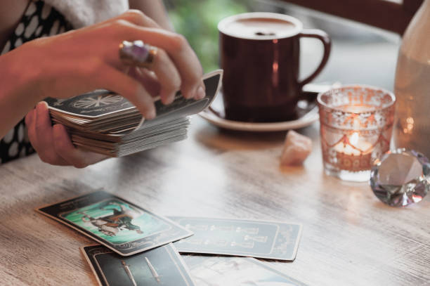 istock Woman is reading Tarot cards in cafe 958066506