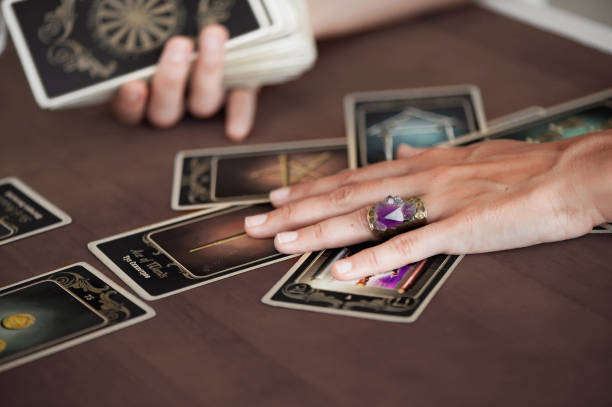 istock Woman is reading Tarot cards in cafe 958068578