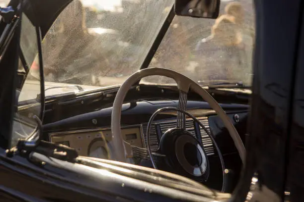 Retro car, vintage steering wheel clock, bright day