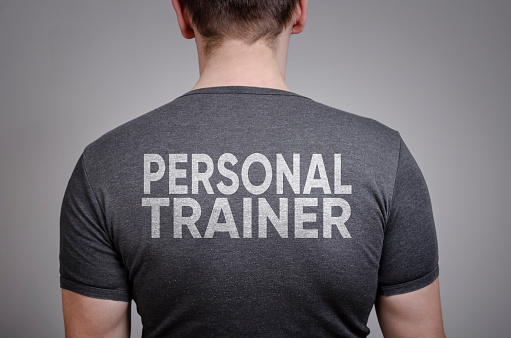 Back view of personal trainer isolated on gray background