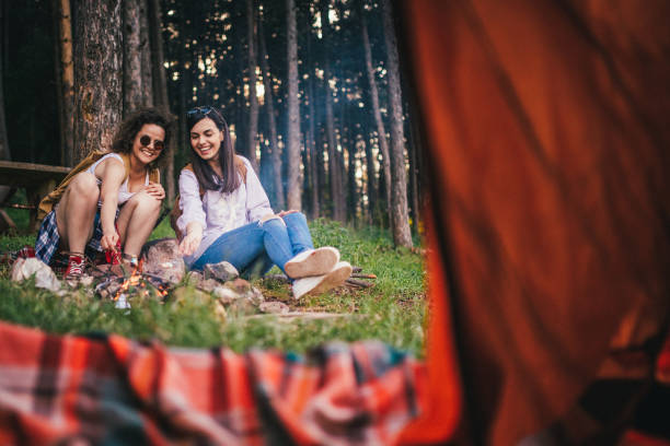 istock Hipster girls camping together 958074704