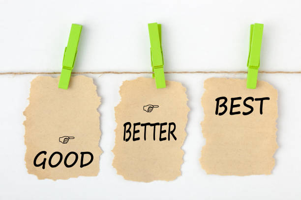 Good Better Best Concept GOOD BETTER BEST writen on old torn paper with clip hanging on white background. Business concept words. practising stock pictures, royalty-free photos & images