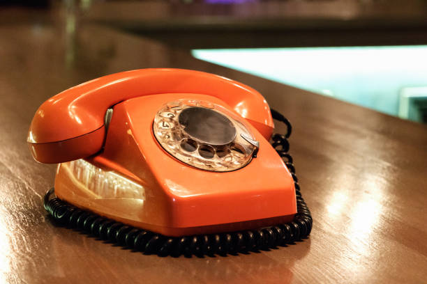 istock Vintage orange telephone in a bar. 958075790