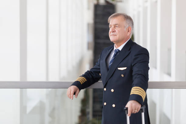istock Experienced Senior pilot waiting at the airport lobby for flight 958082070