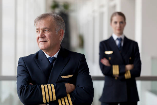 istock Arms folded Senior captain and his female co-pilot 958082160