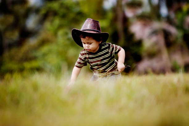 Cute Little Cowboy Walking Around the Field