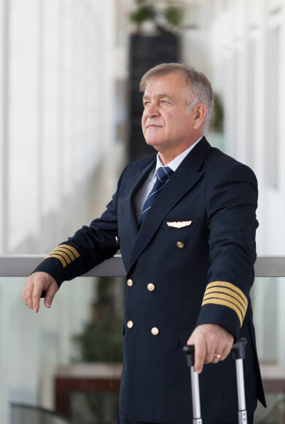 istock Experienced Senior pilot waiting at the airport lobby for flight 958090268