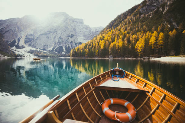 istock Traditional rowing boat on a lake in the Alps in fall 958092252