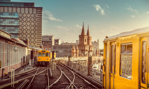 Berlin Oberbaum Bridge with trains at sunset, Berlin Friedrichshain-Kreuzberg, Germany Panoramic view of Berliner U-Bahn with Oberbaum Bridge in the background in golden evening light at sunset with retro vintage Instagram style hipster filter effect, Berlin Friedrichshain-Kreuzberg friedrichshain photos stock pictures, royalty-free photos & images