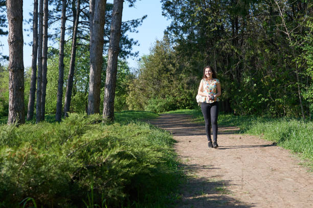 istock young girl walking in spring forest with camera and taking pictures 958104438
