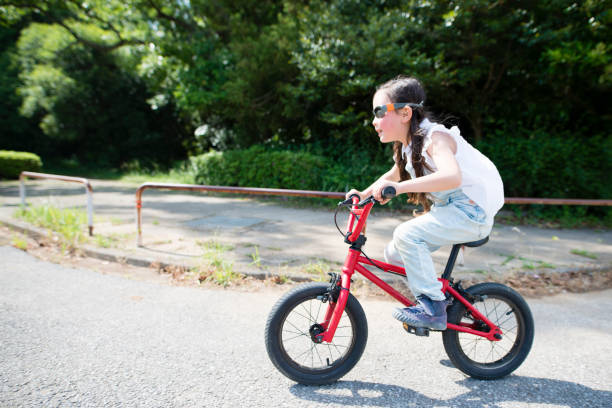 istock Little girl riding a bicycle 958110306
