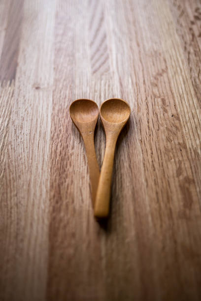 istock Two wooden spoons on oak table 958117368