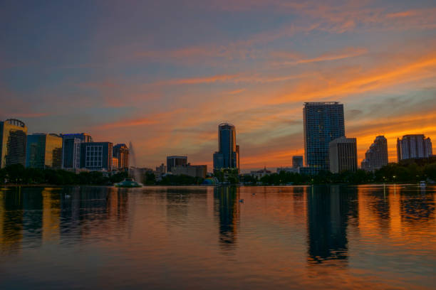 istock Orlando Florida Downtown Skyline During Vibrant Sunset Over Lake Eola 958117758