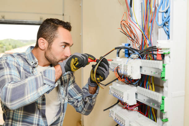 istock handsome young man electrician working on switchboard of house building construction site 958117770