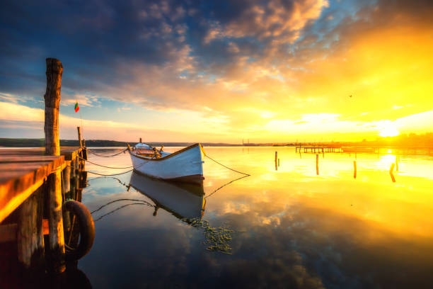 istock Small Dock and Boat at the lake, sunset shot 958118816