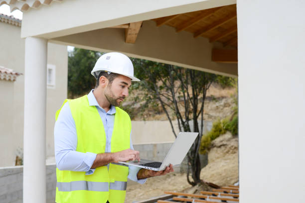 istock handsome young man foreman architect supervising a new house construction site 958119152